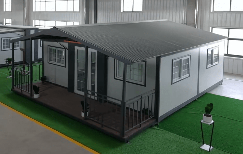 Exterior view of 2-bedroom deluxe folding house

Modern prefabricated orange modular home

Inside view of compact folding prefab unit

Kitchen area with electric setup in prefab home

Folding house with porch roof kit variant