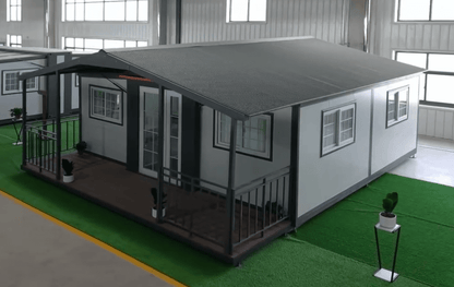 Exterior view of 2-bedroom deluxe folding house

Modern prefabricated orange modular home

Inside view of compact folding prefab unit

Kitchen area with electric setup in prefab home

Folding house with porch roof kit variant