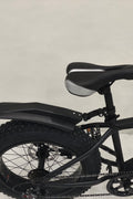 Deviant 20-inch fat tire off-road bike on the beach

Side view of 7-speed fat tire bike with disc brakes

Shimano derailleur on Deviant fat tire bike

Close-up of front disc brake and suspension fork

All-season fat tire bike on snow and gravel terrain