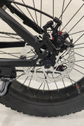 Deviant 20-inch fat tire off-road bike on the beach

Side view of 7-speed fat tire bike with disc brakes

Shimano derailleur on Deviant fat tire bike

Close-up of front disc brake and suspension fork

All-season fat tire bike on snow and gravel terrain