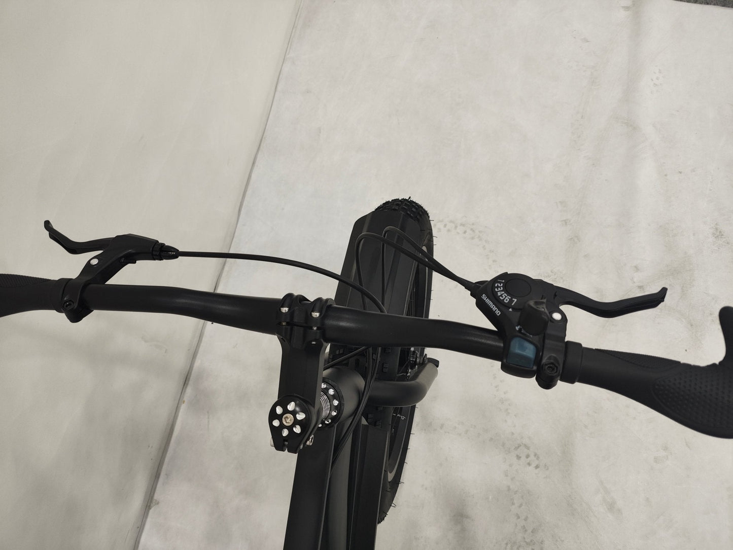 Deviant 20-inch fat tire off-road bike on the beach

Side view of 7-speed fat tire bike with disc brakes

Shimano derailleur on Deviant fat tire bike

Close-up of front disc brake and suspension fork

All-season fat tire bike on snow and gravel terrain
