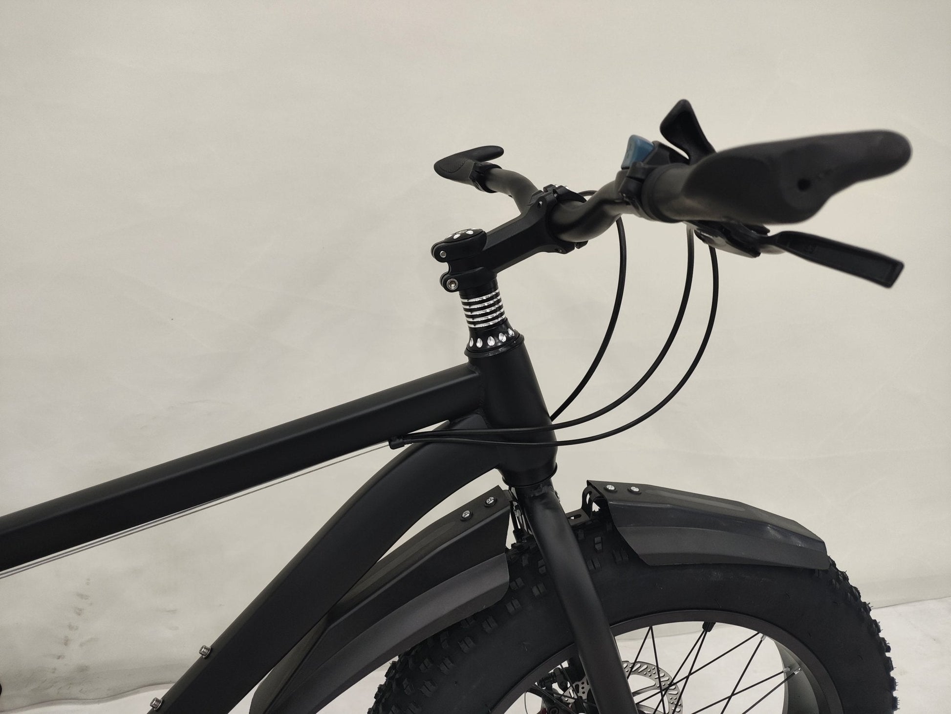Deviant 20-inch fat tire off-road bike on the beach

Side view of 7-speed fat tire bike with disc brakes

Shimano derailleur on Deviant fat tire bike

Close-up of front disc brake and suspension fork

All-season fat tire bike on snow and gravel terrain