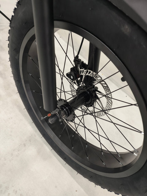 Deviant 20-inch fat tire off-road bike on the beach

Side view of 7-speed fat tire bike with disc brakes

Shimano derailleur on Deviant fat tire bike

Close-up of front disc brake and suspension fork

All-season fat tire bike on snow and gravel terrain