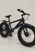 Deviant 20-inch fat tire off-road bike on the beach

Side view of 7-speed fat tire bike with disc brakes

Shimano derailleur on Deviant fat tire bike

Close-up of front disc brake and suspension fork

All-season fat tire bike on snow and gravel terrain