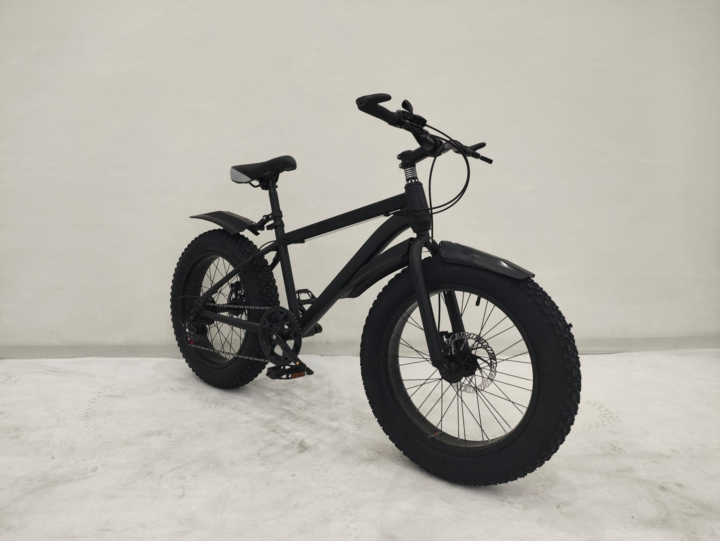 Deviant 20-inch fat tire off-road bike on the beach

Side view of 7-speed fat tire bike with disc brakes

Shimano derailleur on Deviant fat tire bike

Close-up of front disc brake and suspension fork

All-season fat tire bike on snow and gravel terrain