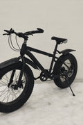 Deviant 20-inch fat tire off-road bike on the beach

Side view of 7-speed fat tire bike with disc brakes

Shimano derailleur on Deviant fat tire bike

Close-up of front disc brake and suspension fork

All-season fat tire bike on snow and gravel terrain