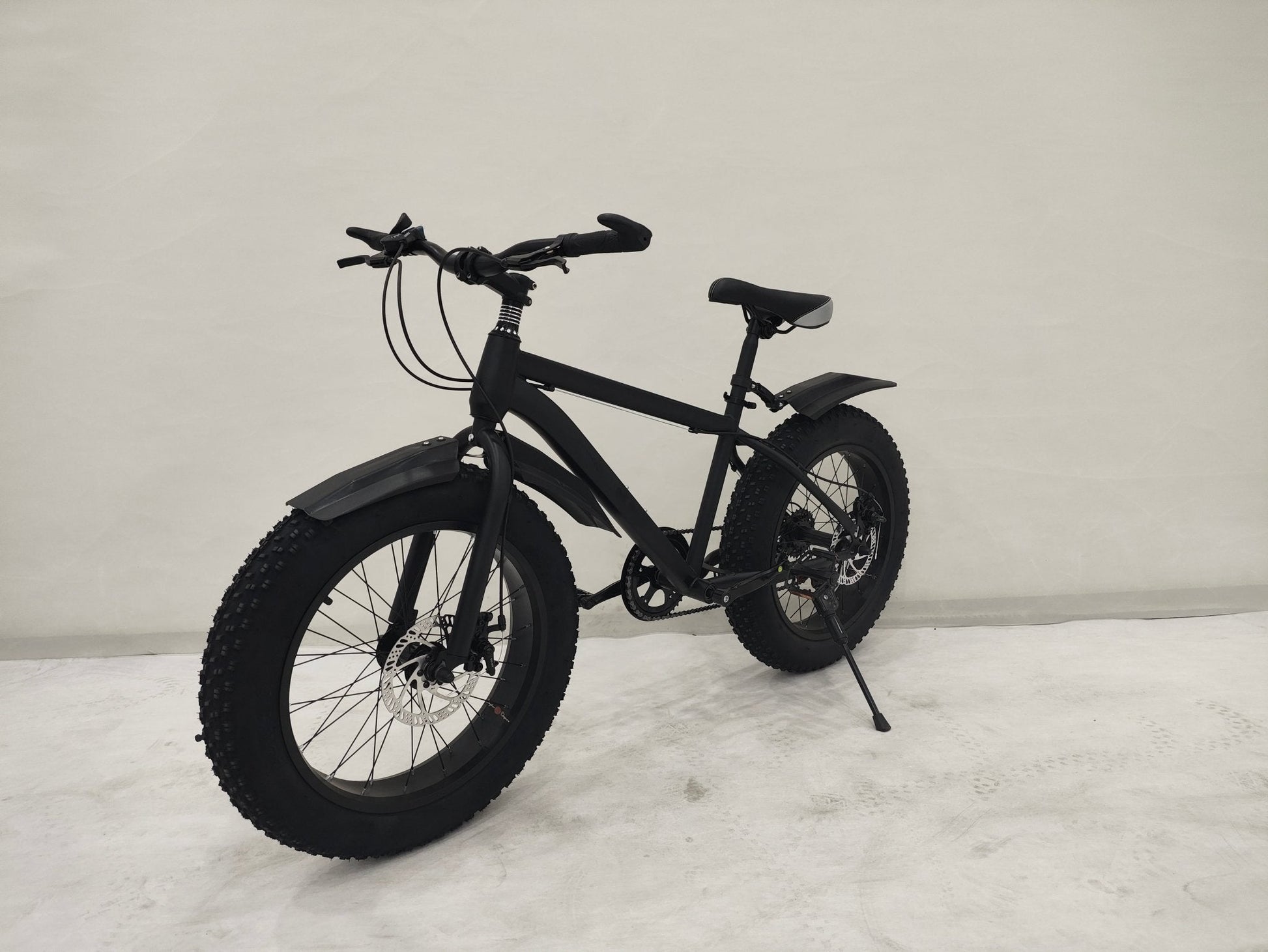 Deviant 20-inch fat tire off-road bike on the beach

Side view of 7-speed fat tire bike with disc brakes

Shimano derailleur on Deviant fat tire bike

Close-up of front disc brake and suspension fork

All-season fat tire bike on snow and gravel terrain