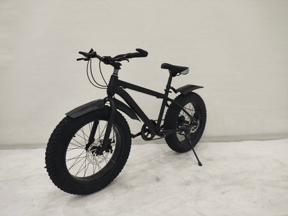 Deviant 20-inch fat tire off-road bike on the beach

Side view of 7-speed fat tire bike with disc brakes

Shimano derailleur on Deviant fat tire bike

Close-up of front disc brake and suspension fork

All-season fat tire bike on snow and gravel terrain