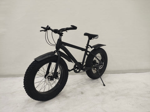 Deviant 20-inch fat tire off-road bike on the beach

Side view of 7-speed fat tire bike with disc brakes

Shimano derailleur on Deviant fat tire bike

Close-up of front disc brake and suspension fork

All-season fat tire bike on snow and gravel terrain