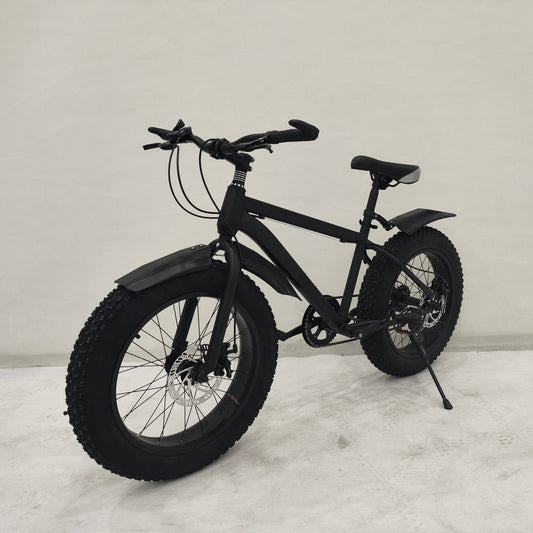 Deviant 20-inch fat tire off-road bike on the beach

Side view of 7-speed fat tire bike with disc brakes

Shimano derailleur on Deviant fat tire bike

Close-up of front disc brake and suspension fork

All-season fat tire bike on snow and gravel terrain
