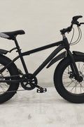 Deviant 20-inch fat tire off-road bike on the beach

Side view of 7-speed fat tire bike with disc brakes

Shimano derailleur on Deviant fat tire bike

Close-up of front disc brake and suspension fork

All-season fat tire bike on snow and gravel terrain