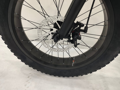 Deviant 20-inch fat tire off-road bike on the beach

Side view of 7-speed fat tire bike with disc brakes

Shimano derailleur on Deviant fat tire bike

Close-up of front disc brake and suspension fork

All-season fat tire bike on snow and gravel terrain
