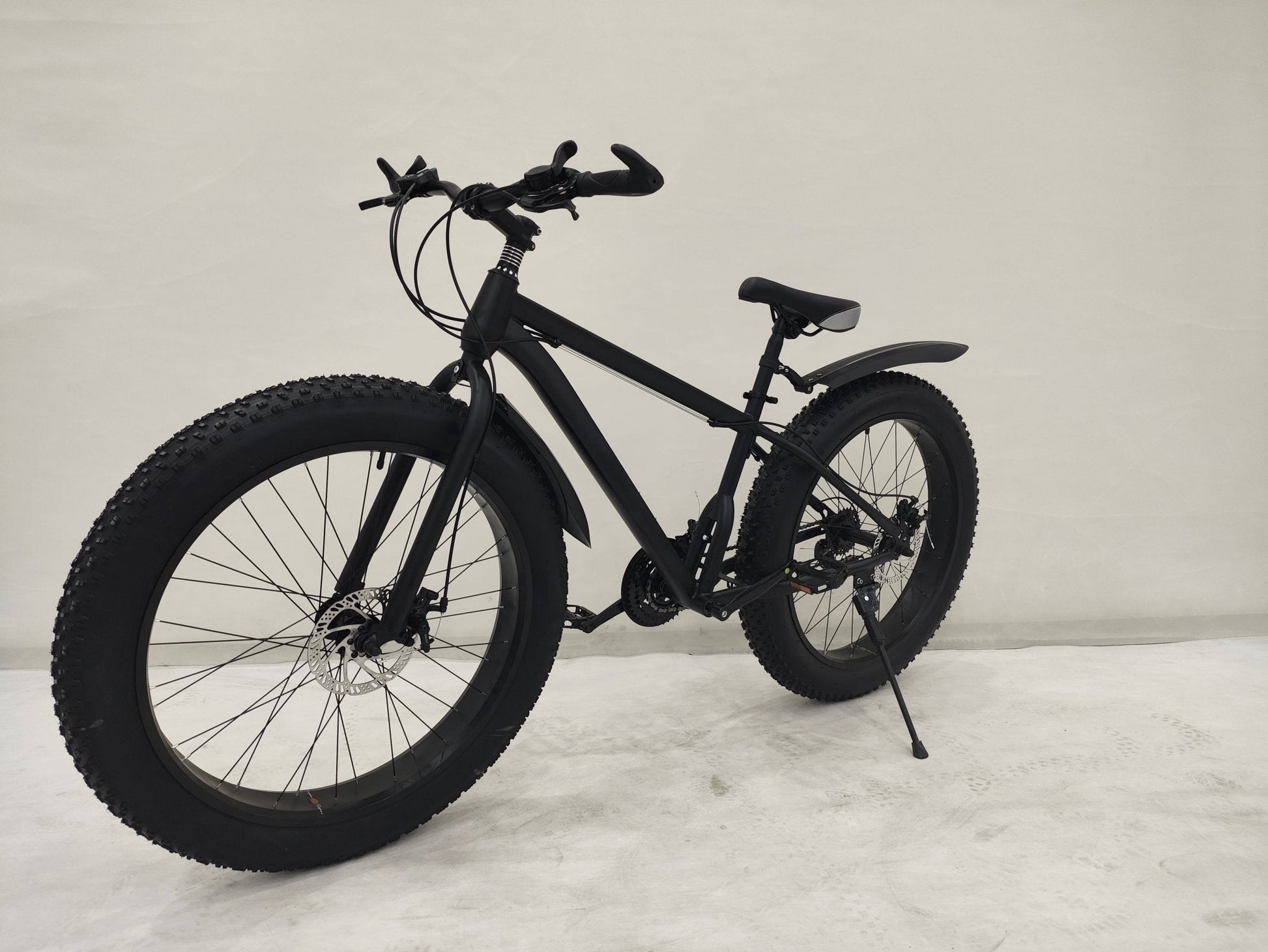 Deviant 26 inch fat tire bike side view on beach
Close-up of Shimano gear and disc brakes
All-terrain mountain bike with wide tires
Fat bike for snow, sand, and trails - Deviant 26 inch