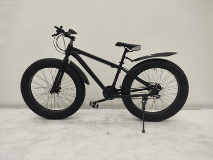 Deviant 26 inch fat tire bike side view on beach
Close-up of Shimano gear and disc brakes
All-terrain mountain bike with wide tires
Fat bike for snow, sand, and trails - Deviant 26 inch