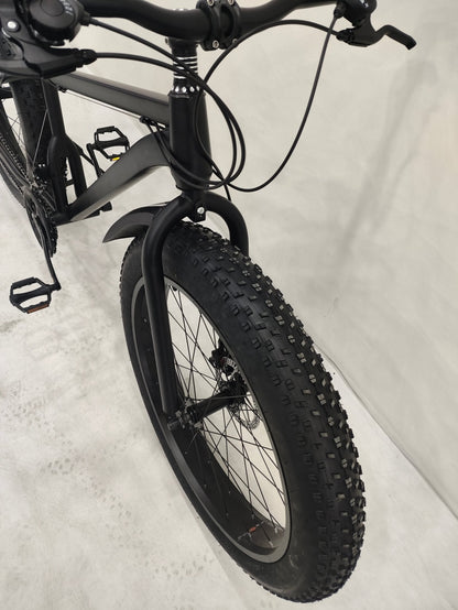 Deviant 26 inch fat tire bike side view on beach
Close-up of Shimano gear and disc brakes
All-terrain mountain bike with wide tires
Fat bike for snow, sand, and trails - Deviant 26 inch