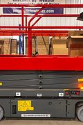 GTJZ08 Electric Scissor Lift full view in warehouse

Platform view showing foldable guardrails

Lift extended to 10M with worker on platform

Side profile highlighting tire system

Control panel and safety features close-up