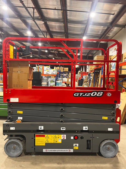 GTJZ08 Electric Scissor Lift full view in warehouse

Platform view showing foldable guardrails

Lift extended to 10M with worker on platform

Side profile highlighting tire system

Control panel and safety features close-up