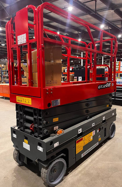 GTJZ08 Electric Scissor Lift full view in warehouse

Platform view showing foldable guardrails

Lift extended to 10M with worker on platform

Side profile highlighting tire system

Control panel and safety features close-up