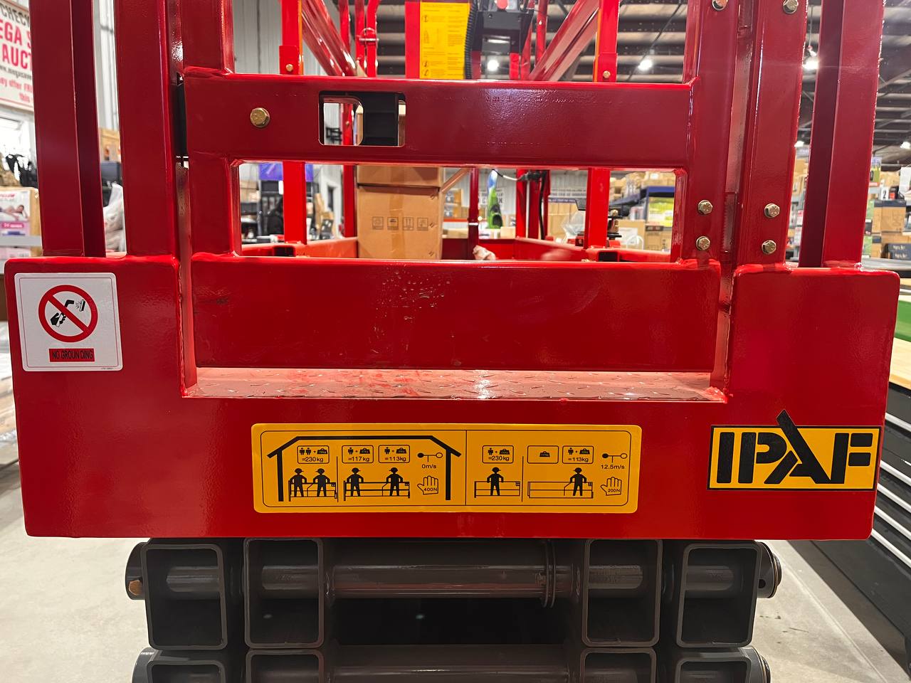 GTJZ08 Electric Scissor Lift full view in warehouse

Platform view showing foldable guardrails

Lift extended to 10M with worker on platform

Side profile highlighting tire system

Control panel and safety features close-up