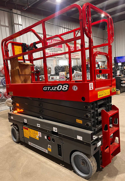 GTJZ08 Electric Scissor Lift full view in warehouse

Platform view showing foldable guardrails

Lift extended to 10M with worker on platform

Side profile highlighting tire system

Control panel and safety features close-up