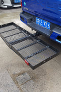 Mounted hitch cargo basket on truck for carrying travel and camping gear
