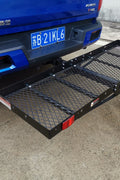 Folded hitch cargo carrier attached to 2-inch receiver for easy storage