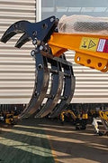 1 Ton Mini Excavator with red exterior and enclosed cab

Excavator attachments: auger, rake, ripper tooth

Briggs & Stratton engine close-up in compact excavator

Compact excavator operating on residential job site

Interior view of enclosed cab on mini excavator