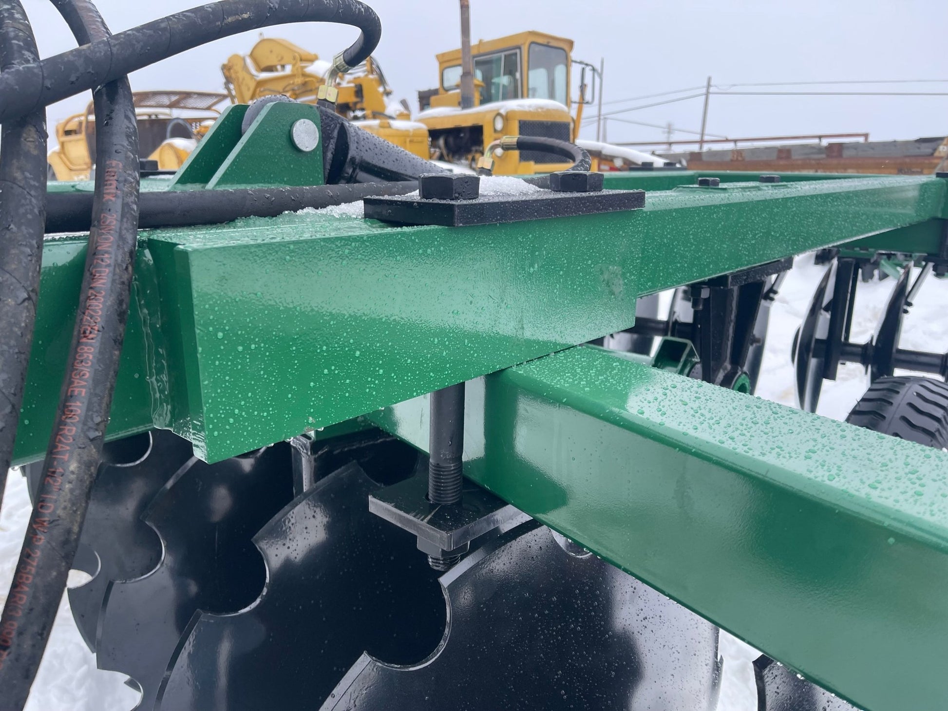 10 FT Hydraulic Offset Tractor Disc Harrow in field setup
Side view of 10-foot disc harrow with 28 manganese steel blades
Rear blade configuration of hydraulic disc harrow
Top view showing hydraulic tubing and disc spacing
Offset disc harrow mounted on green tractor for field work