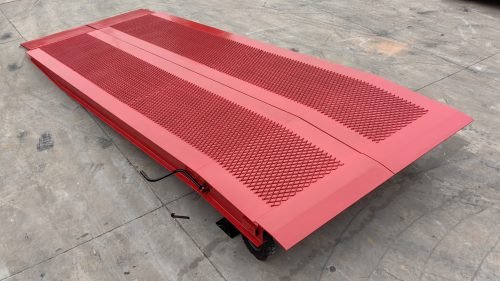 Side view of 10x25 red steel loading dock ramp with safety rail