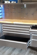 84" stainless steel tool bench with LED lighting and drawers

Solid wood top garage workbench with 11 storage drawers

Professional stainless steel tool station with LED bar

Close-up of drawer handles on heavy-duty tool bench

Industrial workbench with built-in lights and hardwood surface