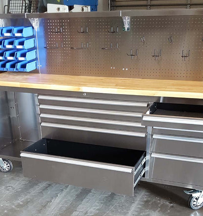 84" stainless steel tool bench with LED lighting and drawers

Solid wood top garage workbench with 11 storage drawers

Professional stainless steel tool station with LED bar

Close-up of drawer handles on heavy-duty tool bench

Industrial workbench with built-in lights and hardwood surface