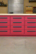 Heavy-duty steel workbench with 12 drawers and 2 cabinets – front view
Red metal tool storage bench for garage or workshop use
Industrial-grade 12-drawer workbench with welded backsplash