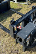 Rotating hydraulic skid steer pallet fork with 42” tines

HRB11172A attachment showing 127° rotation

Heavy-duty quick attach pallet forks for skid steer

Close-up of reinforced steel fork frame

Rotating fork in lifted pallet position on gravel site