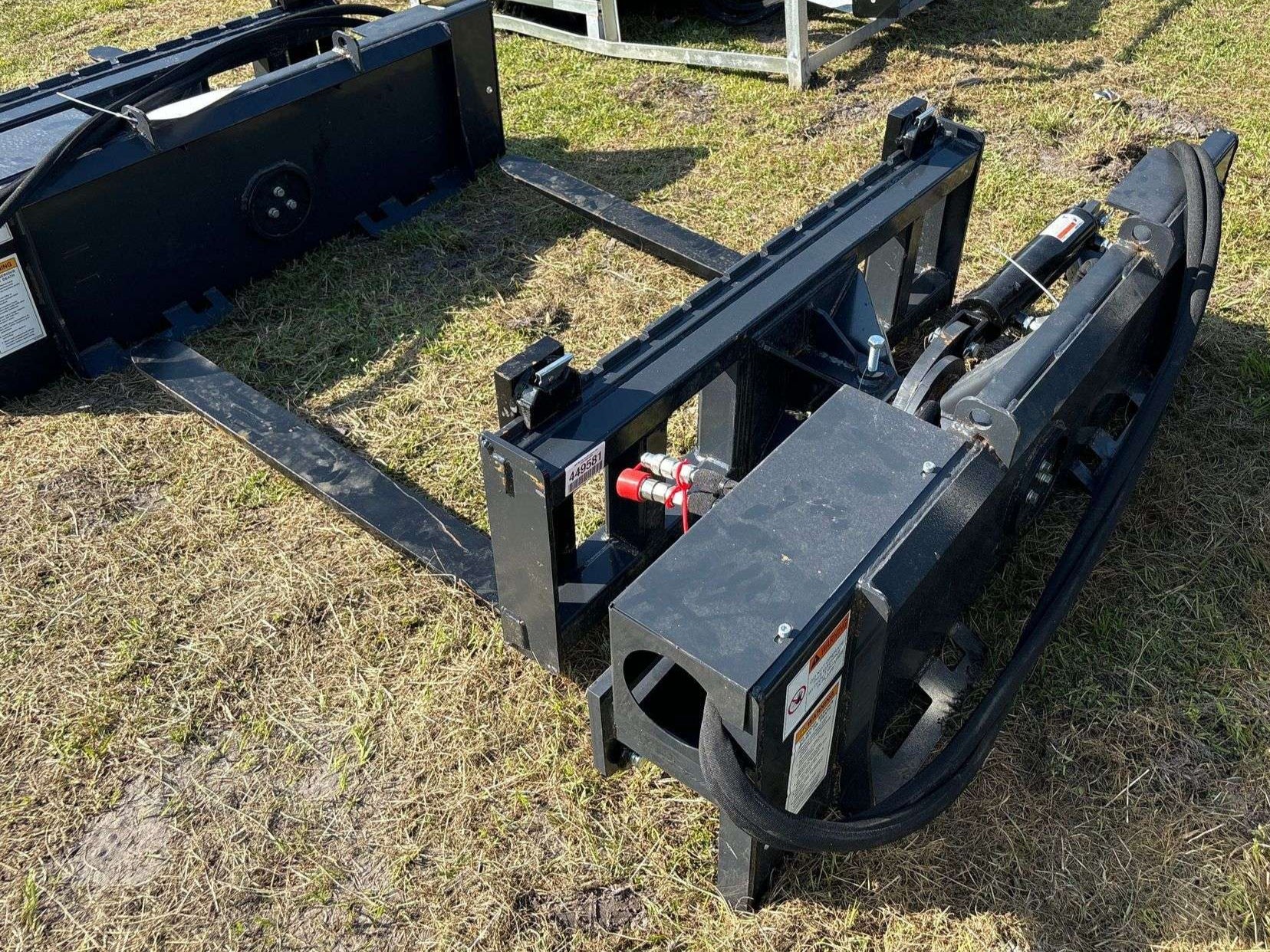 Rotating hydraulic skid steer pallet fork with 42” tines

HRB11172A attachment showing 127° rotation

Heavy-duty quick attach pallet forks for skid steer

Close-up of reinforced steel fork frame

Rotating fork in lifted pallet position on gravel site
