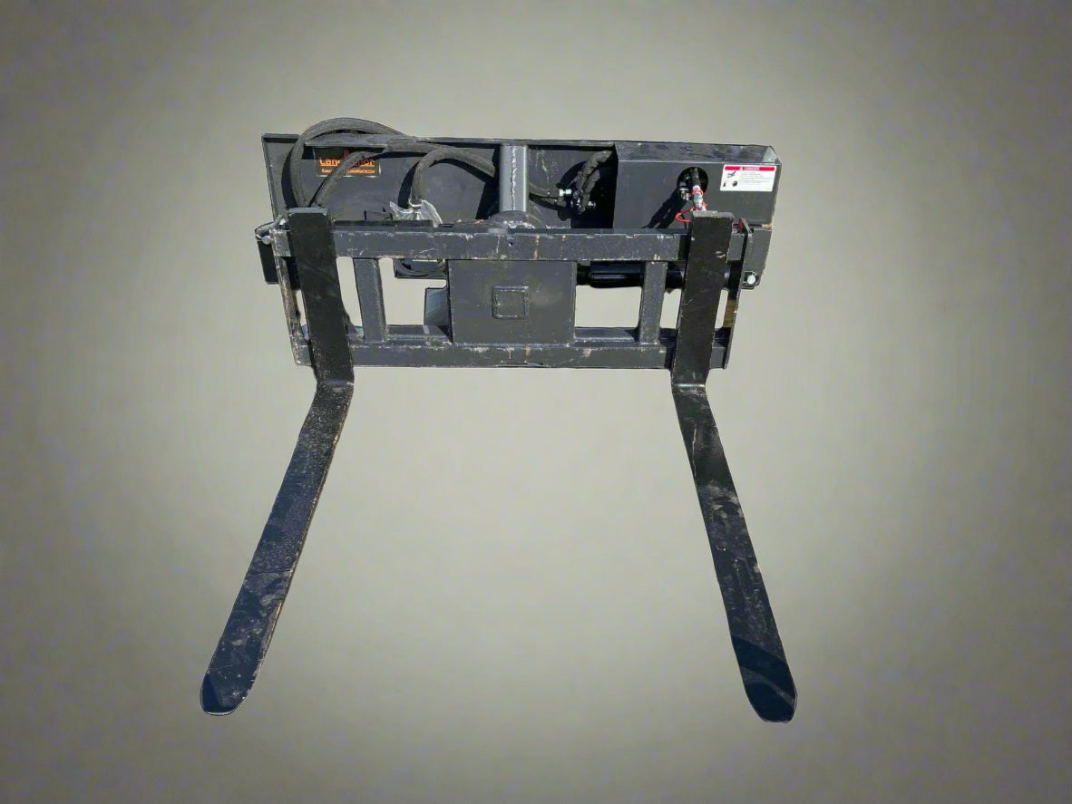 Rotating hydraulic skid steer pallet fork with 42” tines

HRB11172A attachment showing 127° rotation

Heavy-duty quick attach pallet forks for skid steer

Close-up of reinforced steel fork frame

Rotating fork in lifted pallet position on gravel site