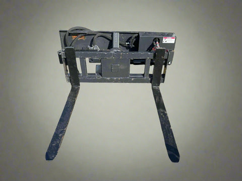 Rotating hydraulic skid steer pallet fork with 42” tines

HRB11172A attachment showing 127° rotation

Heavy-duty quick attach pallet forks for skid steer

Close-up of reinforced steel fork frame

Rotating fork in lifted pallet position on gravel site