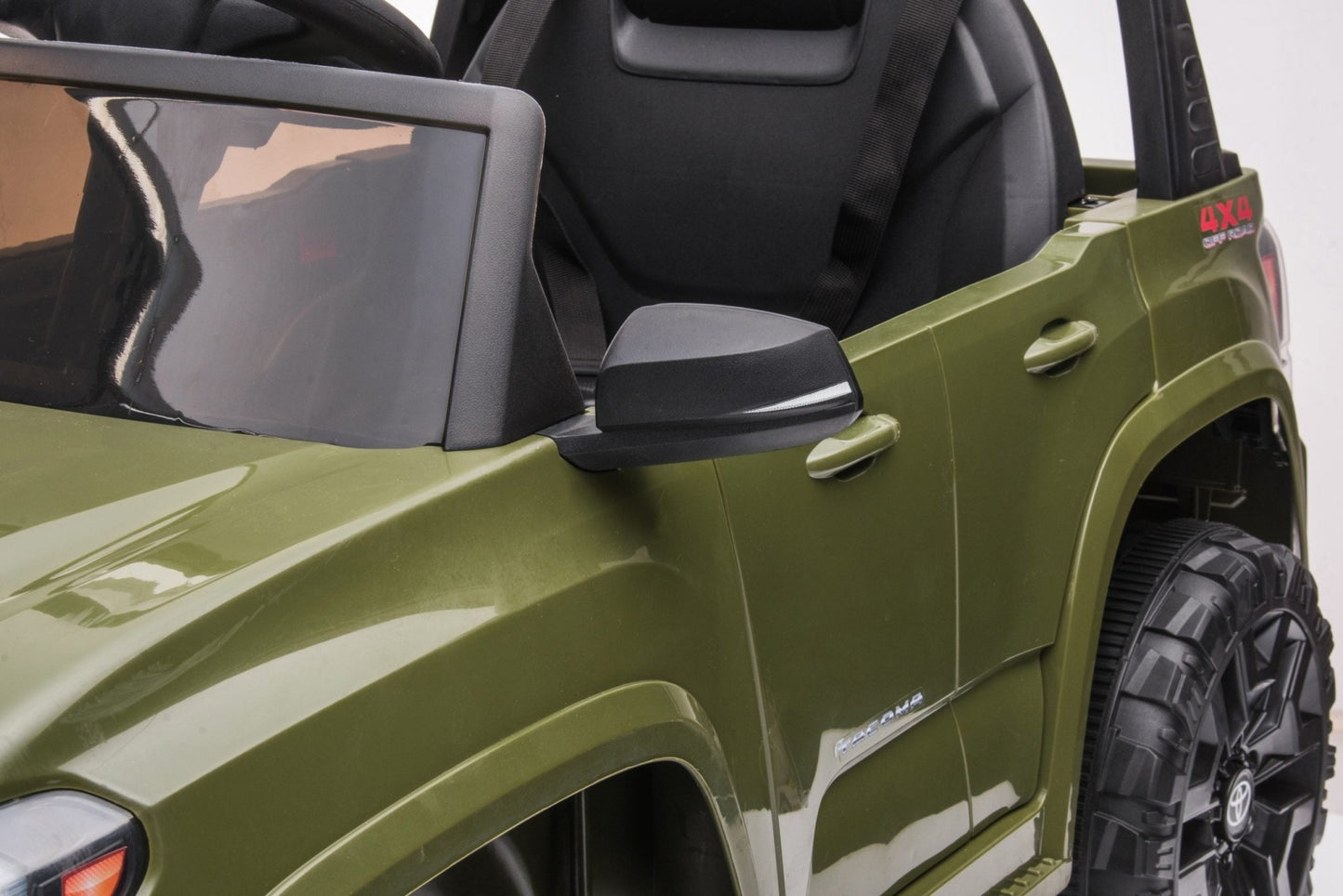 Olive green Toyota-style ride-on pickup truck for kids

Side view of remote-control kids truck with leather seat

Child’s electric ride-on truck with LED headlights

Toyota ride-on truck in olive green with suspension

Battery-powered pickup truck for toddlers