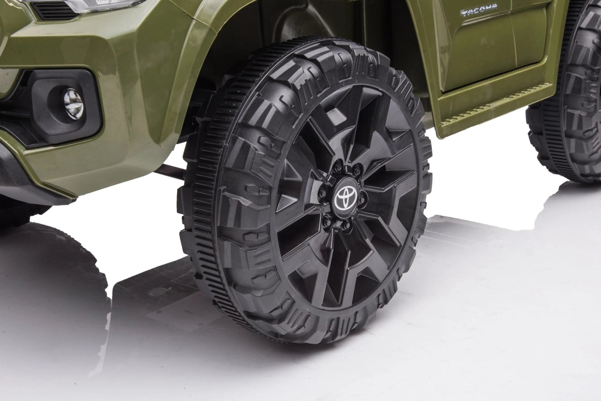 Olive green Toyota-style ride-on pickup truck for kids

Side view of remote-control kids truck with leather seat

Child’s electric ride-on truck with LED headlights

Toyota ride-on truck in olive green with suspension

Battery-powered pickup truck for toddlers