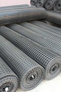 BX131X164 biaxial geogrid roll for soil reinforcement
Geogrid mesh for road base construction
Heavy-duty bidirectional geogrid unrolled on gravel
Close-up of high-tensile geogrid fabric