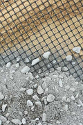 BX131X164 biaxial geogrid roll for soil reinforcement
Geogrid mesh for road base construction
Heavy-duty bidirectional geogrid unrolled on gravel
Close-up of high-tensile geogrid fabric