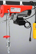 1320 lb electric overhead hoist winch in red
AC-powered hoist with safety hook and carbon steel cable
Heavy-duty electric hoist for garage or shop use
110V overhead winch with lifting hook and motor
Construction site electric lifting hoist with steel housing