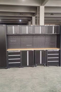 Full 17-piece diamond plate garage cabinet set

Side view of heavy-duty steel tool bench system

Overhead cabinets and drawers with diamond plate finish

Tool bench workstation with storage drawers

Black powder-coated steel cabinet close-up