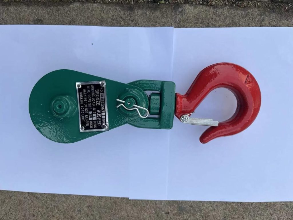 Green snatch block with steel hook

2-ton snatch block pulley close-up

4-ton heavy-duty snatch block for winching

8-ton recovery pulley block with hook

Winch pulley being measured

Towing snatch block in off-road use