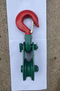 Green snatch block with steel hook

2-ton snatch block pulley close-up

4-ton heavy-duty snatch block for winching

8-ton recovery pulley block with hook

Winch pulley being measured

Towing snatch block in off-road use