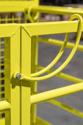 Yellow 2-person forklift safety cage with mesh floor

Forklift lifting steel work platform in industrial setting

OSHA-compliant safety cage with lockable gate

Close-up of forklift cage fork pockets and frame

Overhead maintenance platform for warehouse use