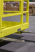 Yellow 2-person forklift safety cage with mesh floor

Forklift lifting steel work platform in industrial setting

OSHA-compliant safety cage with lockable gate

Close-up of forklift cage fork pockets and frame

Overhead maintenance platform for warehouse use