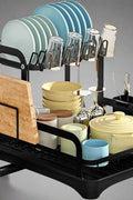 Black 2-tier dish rack with drainboard and accessories

Kitchen dish rack holding plates, cups, and utensils

Close-up of removable drain tray and cup holders

Cutlery holder and cutting board attachment included

Sleek and rustproof multipurpose kitchen organizer