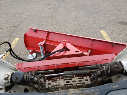 Skid steer clearing snow using Bendall hydraulic snow plow

Bendall 96” red snow plow angled to the side

Close-up of adjustable skid shoes and hydraulic fittings

Rear view of snow blade attached to skid steer

Bolt-on reversible cutting edge on Bendall plow