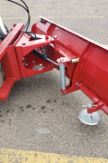 Skid steer clearing snow using Bendall hydraulic snow plow

Bendall 96” red snow plow angled to the side

Close-up of adjustable skid shoes and hydraulic fittings

Rear view of snow blade attached to skid steer

Bolt-on reversible cutting edge on Bendall plow