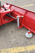 Skid steer clearing snow using Bendall hydraulic snow plow

Bendall 96” red snow plow angled to the side

Close-up of adjustable skid shoes and hydraulic fittings

Rear view of snow blade attached to skid steer

Bolt-on reversible cutting edge on Bendall plow